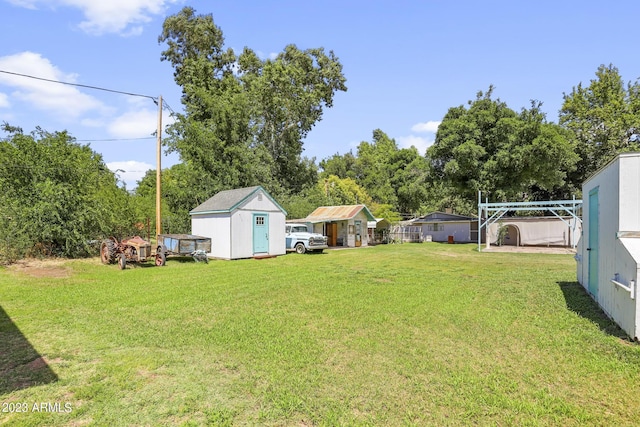 view of yard with an outbuilding and a shed