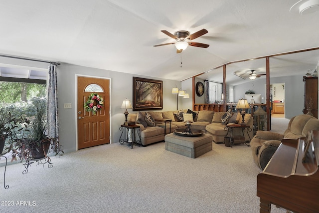 living room featuring vaulted ceiling, carpet flooring, and a ceiling fan