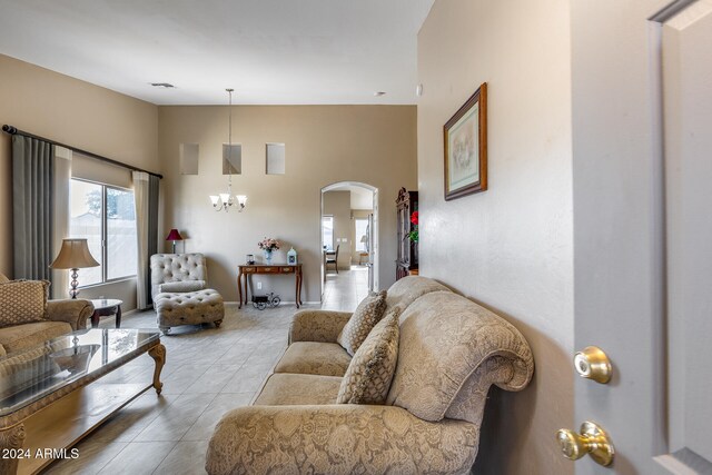 living room featuring light tile patterned floors and a notable chandelier