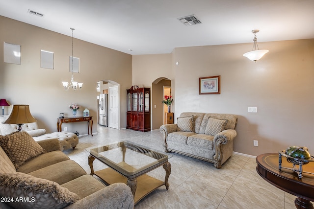 living room featuring vaulted ceiling and a chandelier