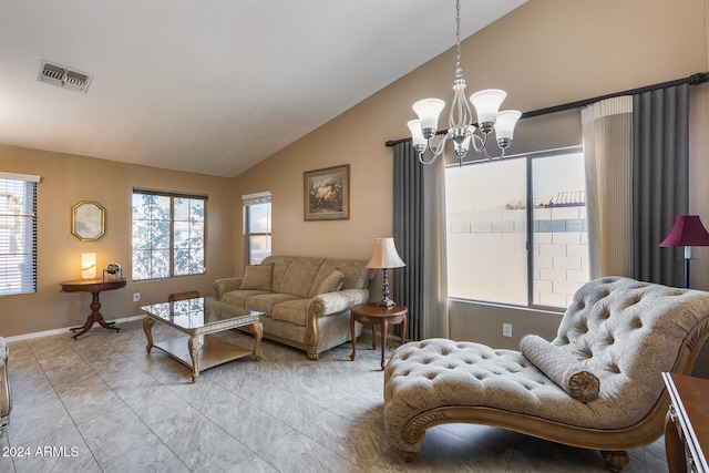 living room with a chandelier and lofted ceiling