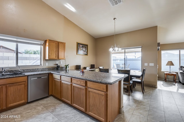 kitchen featuring kitchen peninsula, sink, pendant lighting, an inviting chandelier, and dishwasher