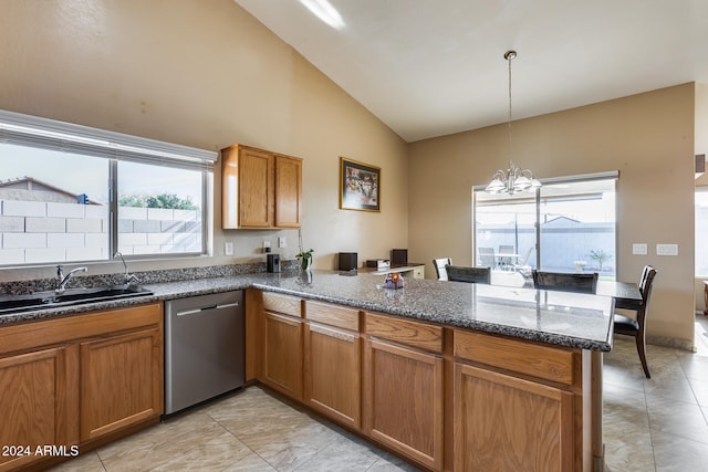 kitchen with kitchen peninsula, plenty of natural light, stainless steel dishwasher, and an inviting chandelier