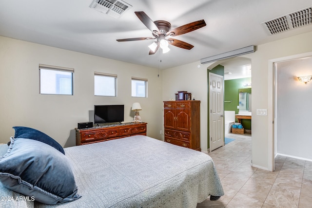 bedroom with ensuite bath and ceiling fan