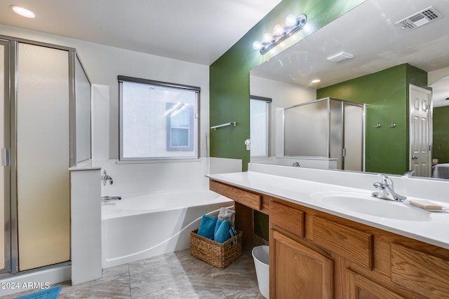 bathroom featuring shower with separate bathtub and vanity