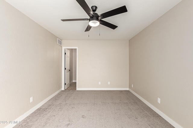 spare room featuring a ceiling fan, baseboards, visible vents, and carpet flooring