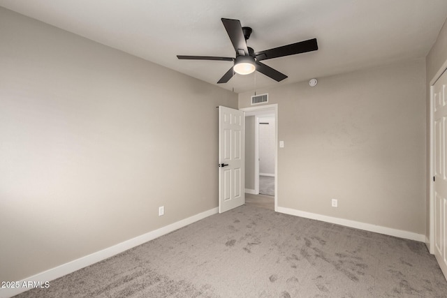 unfurnished bedroom featuring a ceiling fan, carpet flooring, visible vents, and baseboards