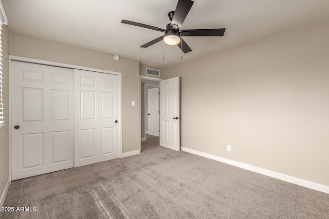 unfurnished bedroom with ceiling fan, carpet flooring, visible vents, baseboards, and a closet