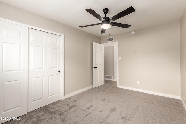 unfurnished bedroom featuring carpet flooring, visible vents, and baseboards