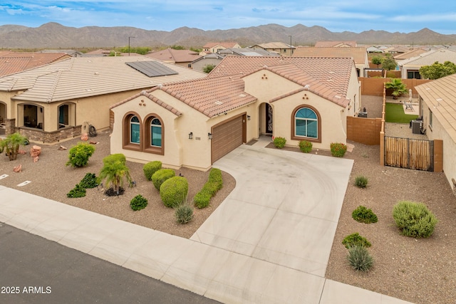 25947 W Oraibi Dr, Buckeye, AZ 85396 - mediterranean / spanish-style home with stucco siding, an attached garage, a tiled roof, and driveway