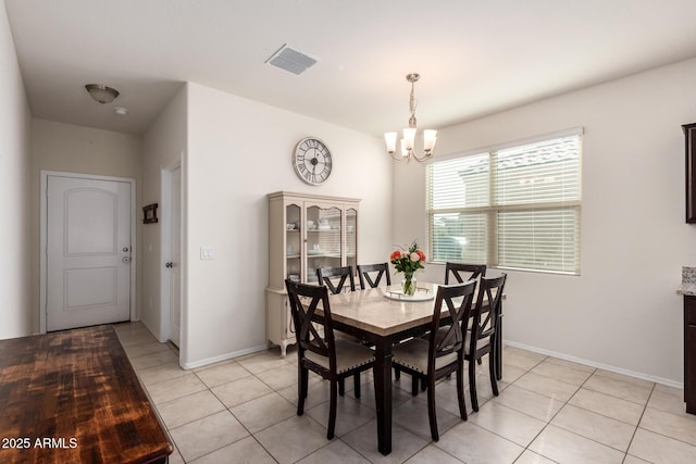 tiled dining area with a notable chandelier