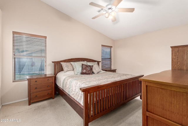 bedroom with vaulted ceiling, light carpet, a ceiling fan, and baseboards