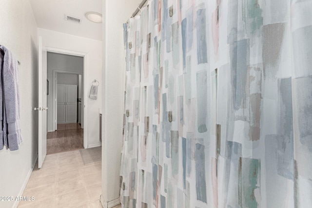 full bathroom with baseboards, visible vents, a shower with shower curtain, and tile patterned floors