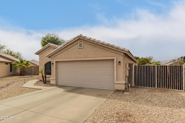 view of front of house with a garage, fence, concrete driveway, a tiled roof, and stucco siding