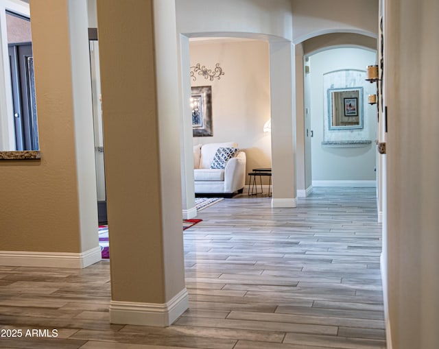 28019 N 115th Pl, Scottsdale, AZ 85262 - hallway featuring arched walkways, wood finished floors, and baseboards