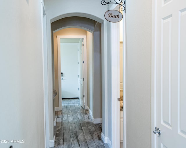 28019 N 115th Pl, Scottsdale, AZ 85262 - hallway featuring arched walkways, dark wood finished floors, and baseboards
