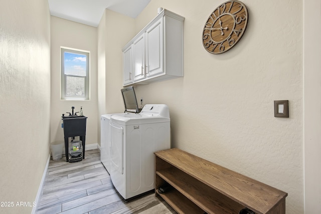 28019 N 115th Pl, Scottsdale, AZ 85262 - washroom featuring washing machine and clothes dryer, light wood-style floors, cabinet space, and baseboards
