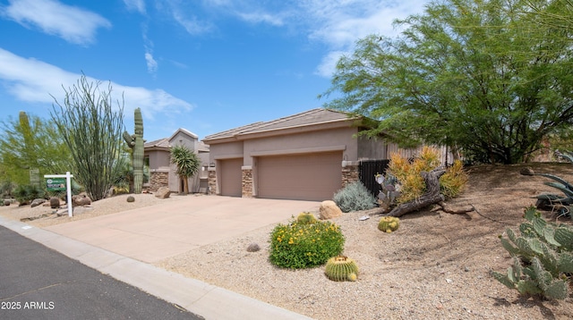 28019 N 115th Pl, Scottsdale, AZ 85262 - view of front of home with stucco siding, stone siding, concrete driveway, and a garage