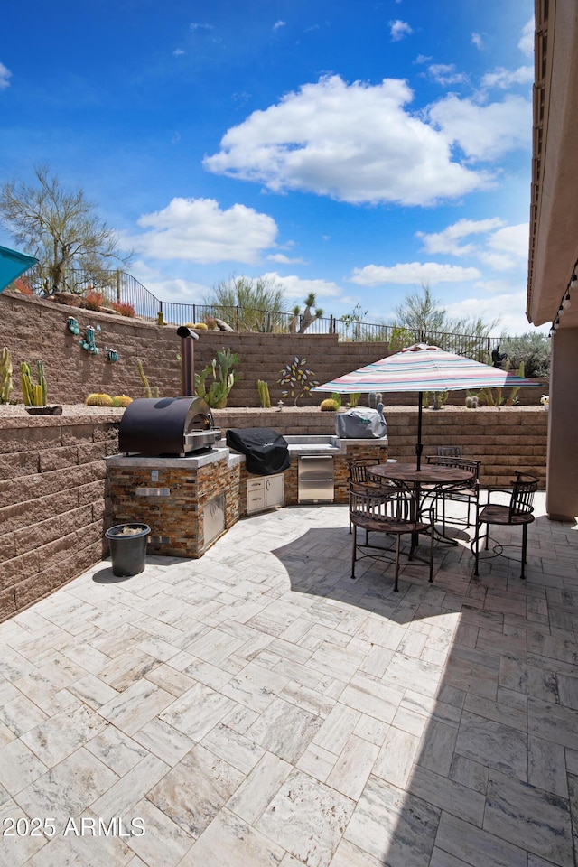 28019 N 115th Pl, Scottsdale, AZ 85262 - view of patio / terrace with an outdoor kitchen, a fenced backyard, outdoor dining space, and a grill