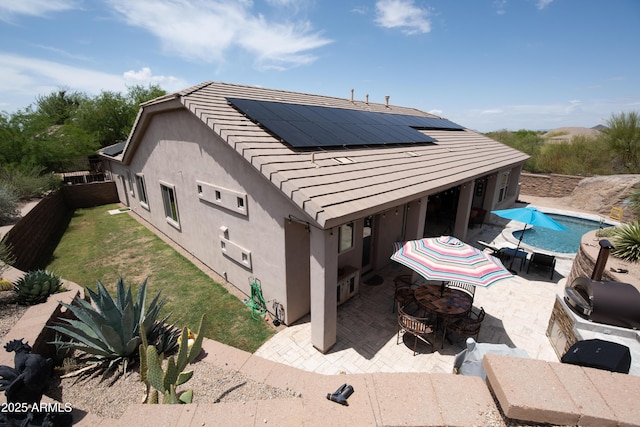 28019 N 115th Pl, Scottsdale, AZ 85262 - rear view of house with a patio area, solar panels, a fenced backyard, stucco siding, and an outdoor pool