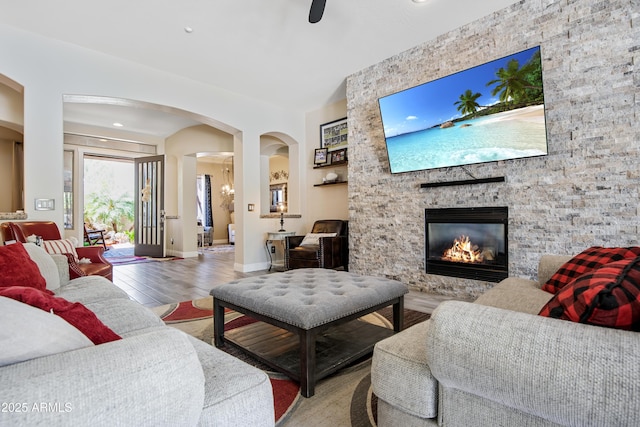 28019 N 115th Pl, Scottsdale, AZ 85262 - living area featuring arched walkways, wood finished floors, a fireplace, and baseboards