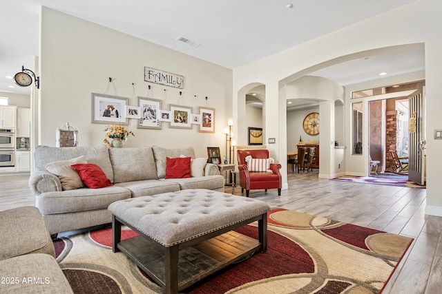 28019 N 115th Pl, Scottsdale, AZ 85262 - living room with light wood-type flooring, arched walkways, and recessed lighting