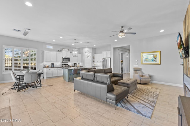 6948 E Quill St, Mesa, AZ 85207 - living room featuring a ceiling fan, recessed lighting, baseboards, and a chandelier