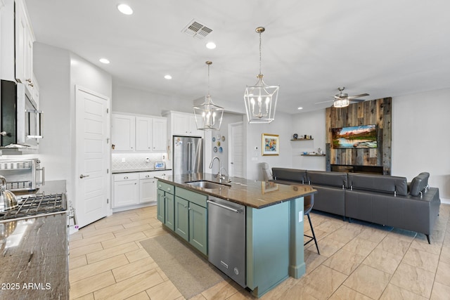 6948 E Quill St, Mesa, AZ 85207 - kitchen with stainless steel appliances, a sink, recessed lighting, white cabinets, and open floor plan