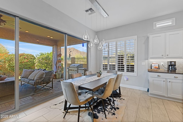 6948 E Quill St, Mesa, AZ 85207 - dining room featuring plenty of natural light and baseboards