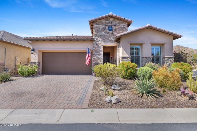 6948 E Quill St, Mesa, AZ 85207 - mediterranean / spanish home featuring stone siding, stucco siding, a garage, and a tile roof