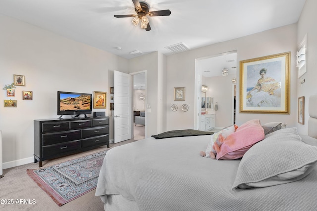 6948 E Quill St, Mesa, AZ 85207 - bedroom with light colored carpet, baseboards, a ceiling fan, and ensuite bathroom