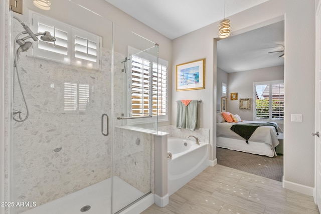 6948 E Quill St, Mesa, AZ 85207 - ensuite bathroom featuring a garden tub, a shower stall, and baseboards