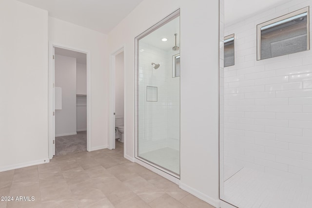 bathroom featuring toilet and an enclosed shower