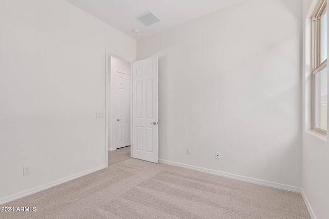 carpeted spare room with a healthy amount of sunlight