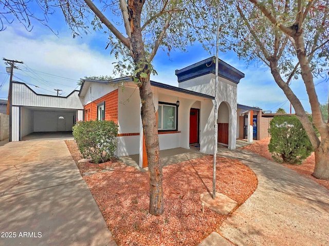 view of front of home with a carport and driveway