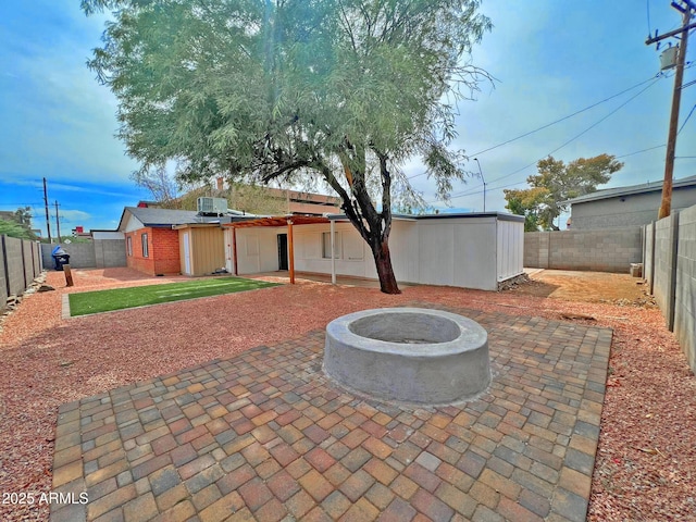 view of patio with a fire pit and a fenced backyard