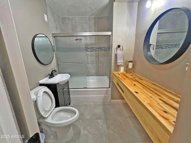 bathroom with enclosed tub / shower combo, toilet, and vanity