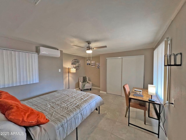 bedroom featuring a wall unit AC, baseboards, a closet, and ceiling fan