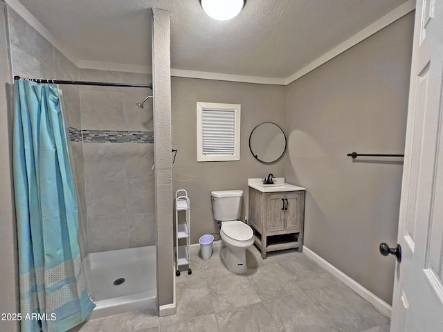 full bathroom featuring a shower stall, baseboards, toilet, vanity, and a textured ceiling