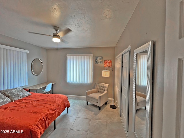 bedroom with light tile patterned floors, baseboards, and ceiling fan