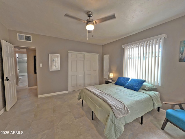 bedroom featuring a closet, visible vents, ceiling fan, and baseboards