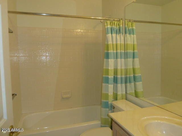 full bathroom with shower / bath combination with curtain, vanity, and toilet