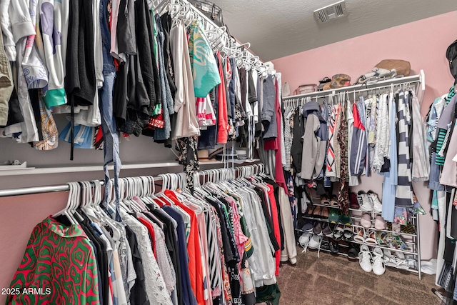 walk in closet with visible vents and carpet flooring