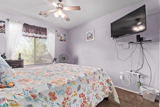 carpeted bedroom with visible vents, baseboards, and ceiling fan