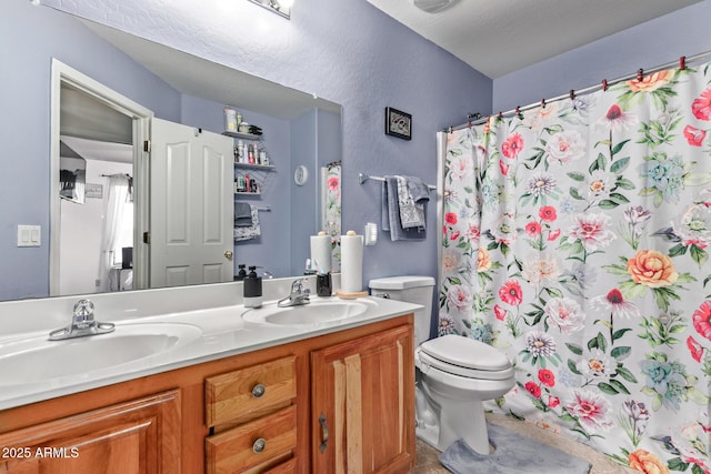 full bathroom featuring a sink, curtained shower, toilet, and double vanity