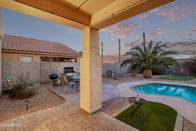 view of swimming pool with a patio area and a fenced backyard