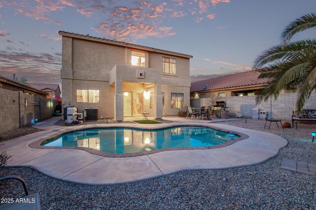 view of pool with a patio, cooling unit, a fenced backyard, and a fenced in pool