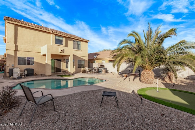outdoor pool featuring a patio area, central air condition unit, and fence