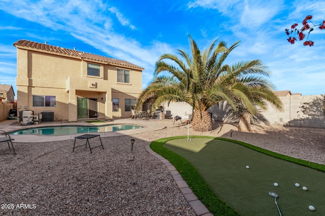view of swimming pool featuring a patio area, a fenced in pool, cooling unit, and a fenced backyard