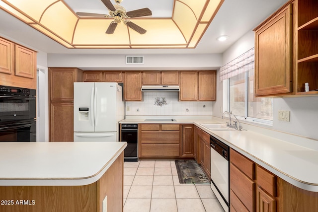 kitchen featuring light tile patterned flooring, tasteful backsplash, sink, ceiling fan, and black appliances